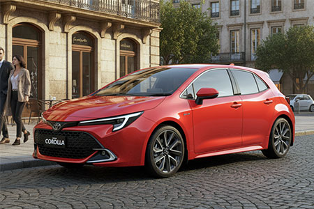 Red Toyota Corolla hatchback parked stylishly